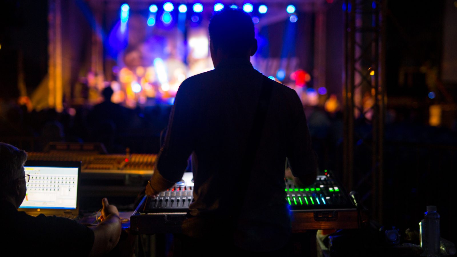 Sound engineer at the front-of-house mixer during a live concert